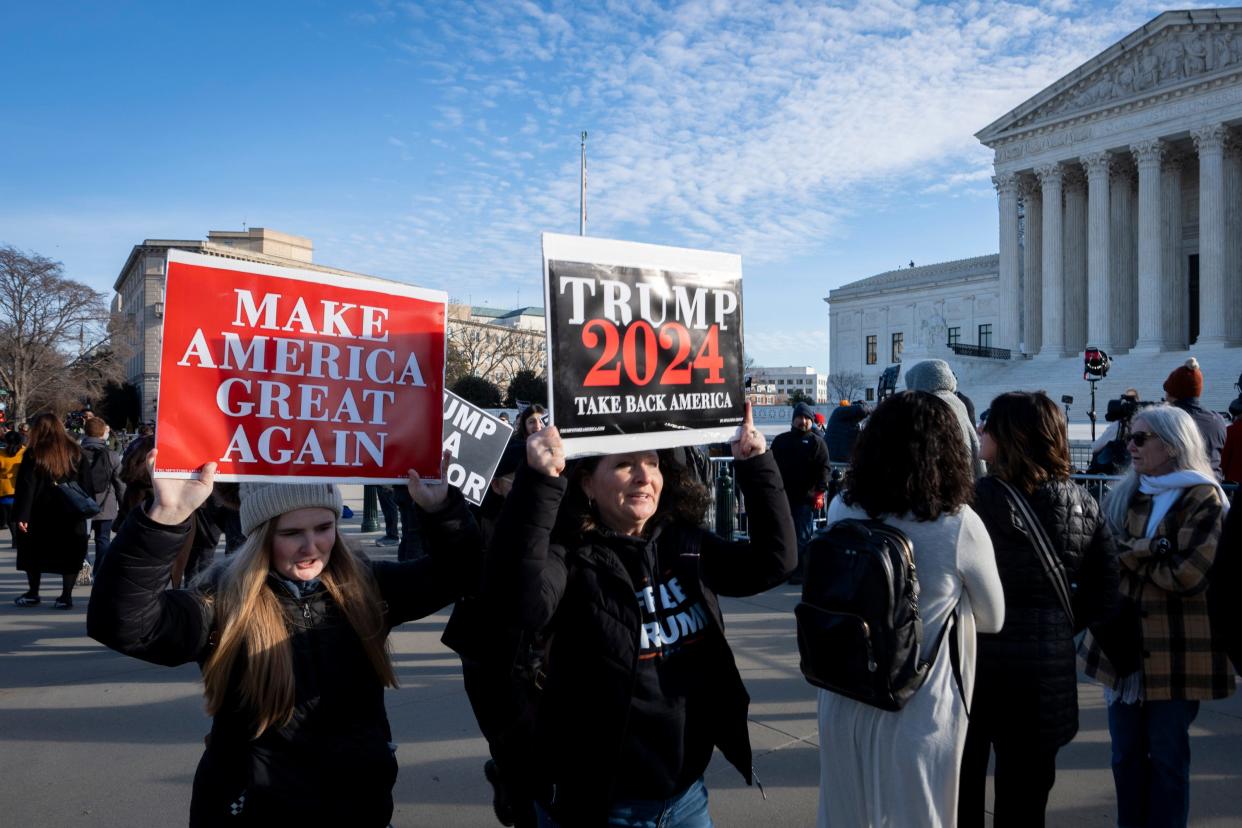Kelli Walk (center) and Rylee Walk (left) of Forest, VA, carry signs as protesters gather outside the U.S. Supreme Court on Feb. 8, 2024.