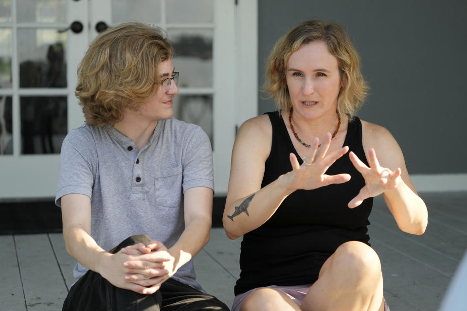 Ray Walker, 17, left, listens as his mother Katie Rives, discuss his moving to Virginia for continued gender-affirming care, Wednesday, June 28, 2023, in Madison County, Miss. This year, Republican Gov. Tate Reeves signed legislation banning gender-affirming care for anyone younger than 18. (AP Photo/Rogelio V. Solis)