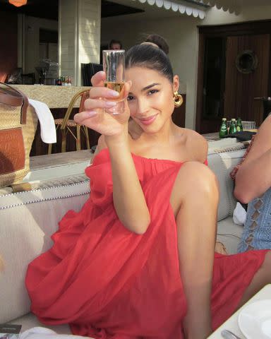 <p>Olivia Culpo/Instagram</p> Olivia Culpo holds up a shot glass in St. Barts.