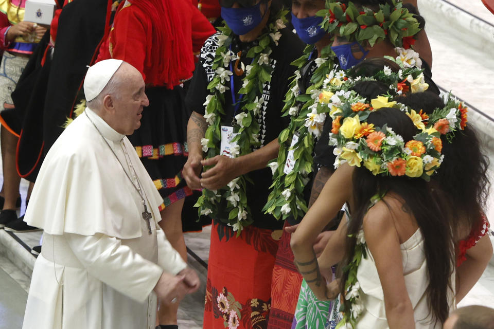 Pope Francis greets a group of Tahiti at the end of his weekly general audience in the Paul VI hall at the Vatican, Wednesday, Aug. 11, 2021. (AP Photo/Riccardo De Luca)