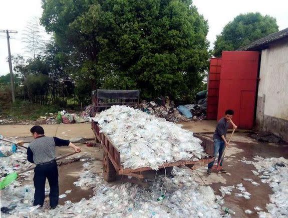 Authorities inspect a truck full of blood bags and syringes, upon other medical waste items in Hunan