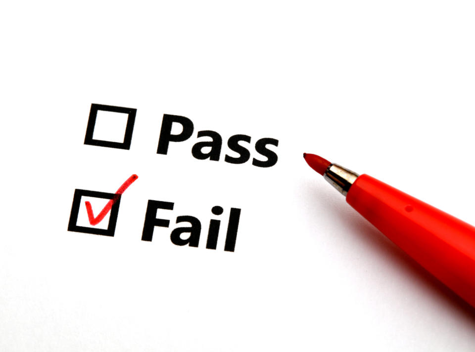 A checklist with "Pass" and "Fail" options, with a red checkmark next to "Fail." A red pen is positioned next to the fail option