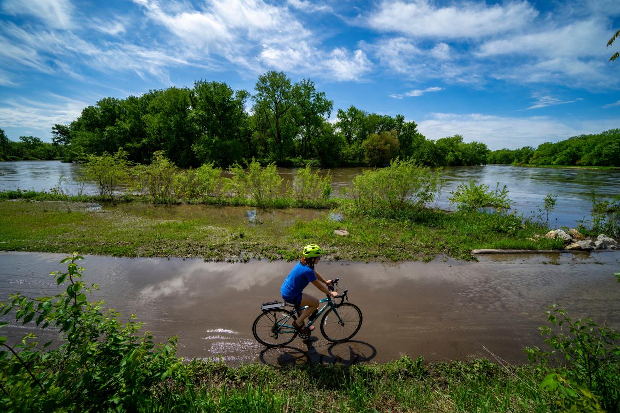 The Raccoon River overflows the Bill Riley Trail at the confluence with Walnut Creek. As abundant rainfall has pushed Iowa's rivers higher, it has also caused farm runoff that is leaving them laden with large amounts of nitrate pollutants.