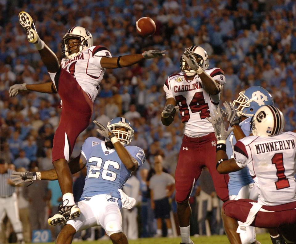 South Carolina's, from left, Kenny McKinley (11), Jared Cook (84), and Captain Munnerlyn (1) break up a North Carolina Hail Mary pass to Brooks Foster (1) at the end zone as time expires in the game Saturday, Oct. 13, 2007 at UNC's Keenan Stadium in Chapel Hill, NC.