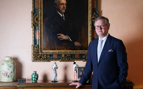 Lord Balfour standing beside a portrait of his ancestor  - Credit:  Christopher Pledger for The Telegraph