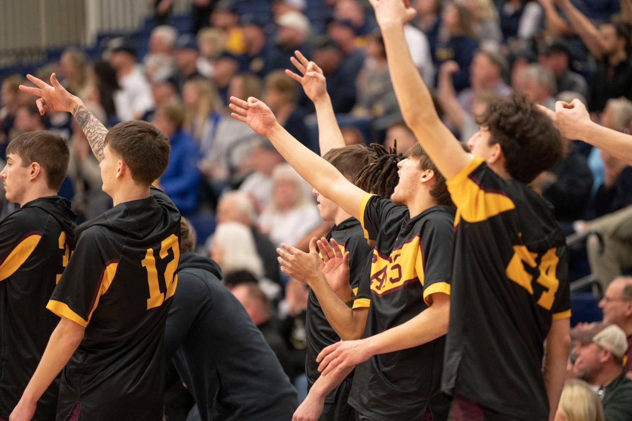 Brandywine players celebrate a three-point shot during the state quarterfinal game at Portage Central High School on Tuesday, March 21, 2023.