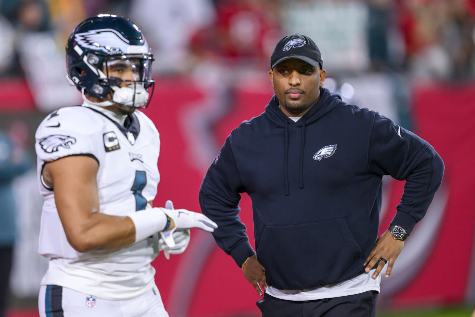 FILE - Philadelphia Eagles offensive coordinator Brian Johnson watches quarterback Jalen Hurts (1) practice on the field before an NFL wild-card playoff football game against the Tampa Bay Buccaneers, Monday, Jan. 15, 2024 in Tampa, Fla. The Eagles have fired offensive coordinator Brian Johnson, a person familiar with the decision told The Associated Press on Tuesday, Jan. 23, 2024.(AP Photo/Doug Murray)