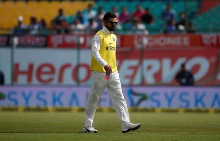 FILE PHOTO: Cricket - India v Australia - Fourth Test cricket match - Himachal Pradesh Cricket Association Stadium, Dharamsala, India - 25/03/17 - India's Virat Kohli walks off the field after a drinks break. REUTERS/Adnan Abidi