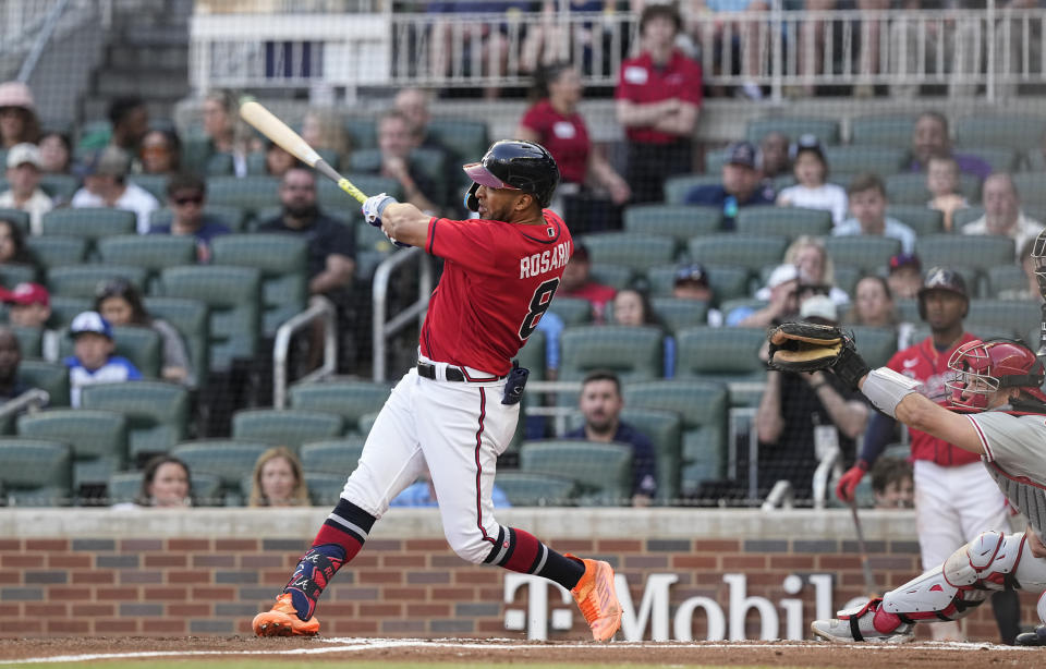 Atlanta Braves' Eddie Rosario follows through on a double against the Philadelphia Phillies during the second inning of a baseball game Friday, May 26, 2023, in Atlanta. (AP Photo/Brynn Anderson)