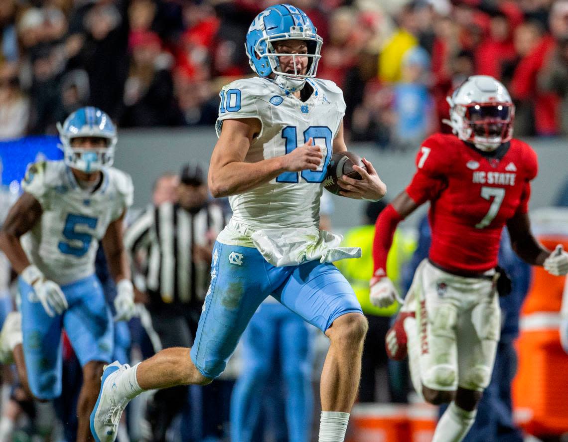 North Carolina quarterback Drake Maye (10) breaks open on a 56-yard gain in the third quarter against N.C. State on Saturday, November 25, 2023 at Carter-Finley Stadium in Raleigh, N.C.