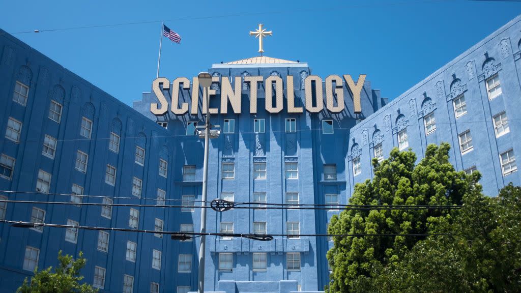 a large blue building with the scientology emblem across the top