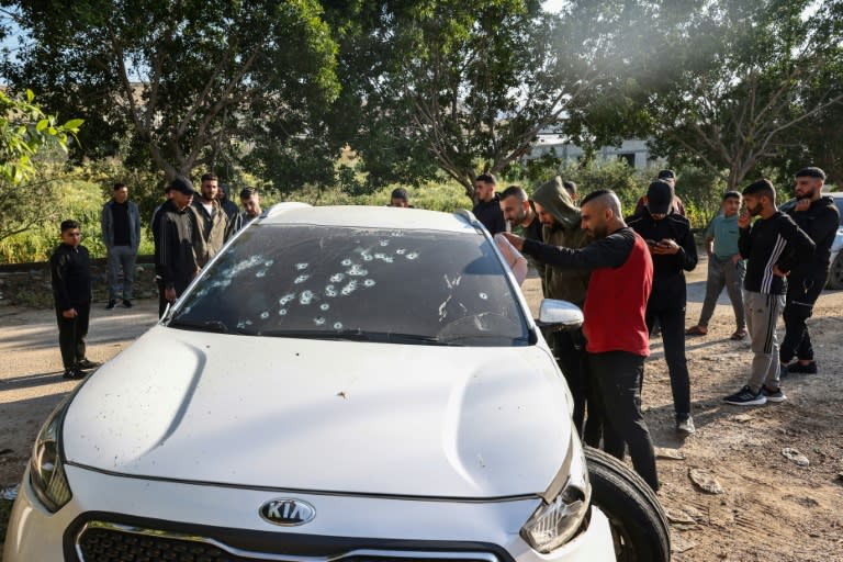 Palestinians check a bullet-riddled car following the raid by Israeli forces near Tubas in the occupied West Bank (Zain JAAFAR)