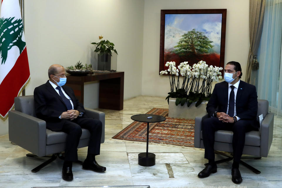 In this photo released by the Lebanese government, Lebanese President Michel Aoun, left, meets with Lebanese Prime Minister-Designate Saad Hariri, at the presidential palace, in Baabda, east of Beirut, Lebanon, Monday, March. 22, 2021. Talks on the formation of a new Cabinet in Lebanon collapsed Monday, heralding more economic and financial collapse for the small Arab country. (Dalati Nohra/Lebanese Official Government via AP)