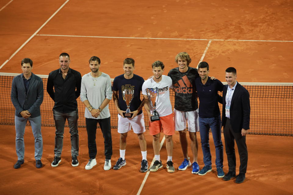 Dominic Thiem (4th R) and runner-up Filip Krajinovic (4th L) pose with their trophies after the final match along with Dusan Lajovic, Viktor Troicki, Grigor Dimitov, Alexander Zverev, Novak Djokovic and Djordje Djokovic at the Adria Tour charity exhibition.