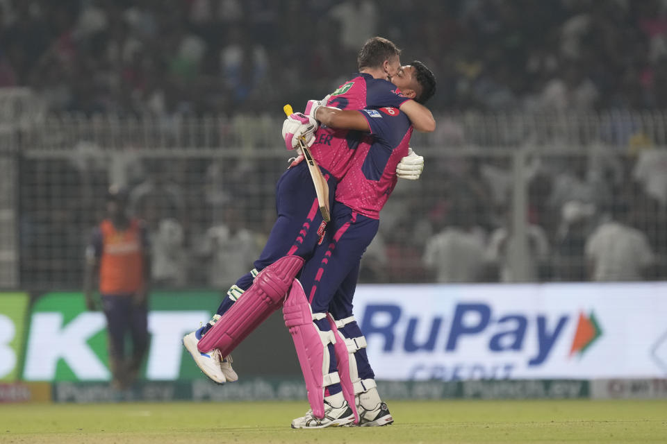 Rajasthan Royals' Jos Buttler and Avesh Khan celebrate their win against Kolkata Knight Riders during the Indian Premier League cricket match in Kolkata, India, Tuesday, April 16, 2024. (AP Photo/Bikas Das)