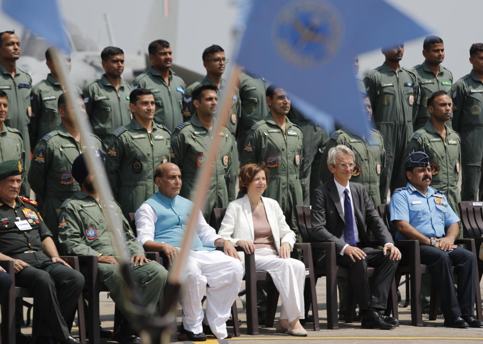 Indian Defense Minister Rajnath Singh, sitting third left and French Defense Minister Florence Parly, sitting third right, pose for a group photo with Rafale squadron during an induction ceremony of French-made Rafale fighter jets at Air Force Station Ambala, India, Thursday, Sept.10, 2020. The first batch of five planes, part of a $8.78 billion deal signed between the two countries in 2016 had arrived here in July. (AP Photo/Manish Swarup)