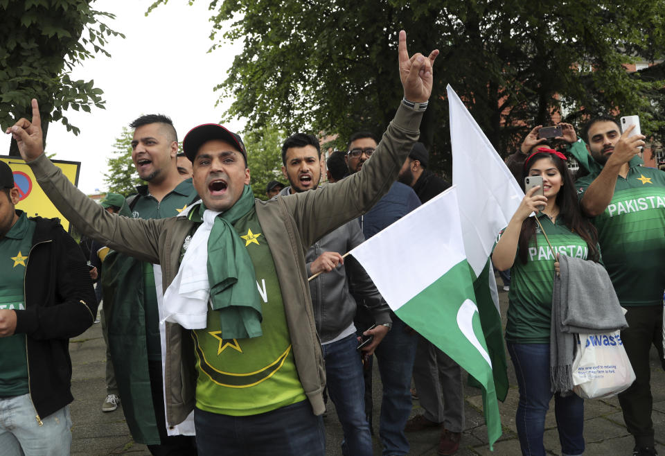 Pakistan fans dance as they arrive before the start of the Cricket World Cup match between India and Pakistan outside Old Trafford in Manchester, England, Sunday, June 16, 2019. (AP Photo/Aijaz Rahi)