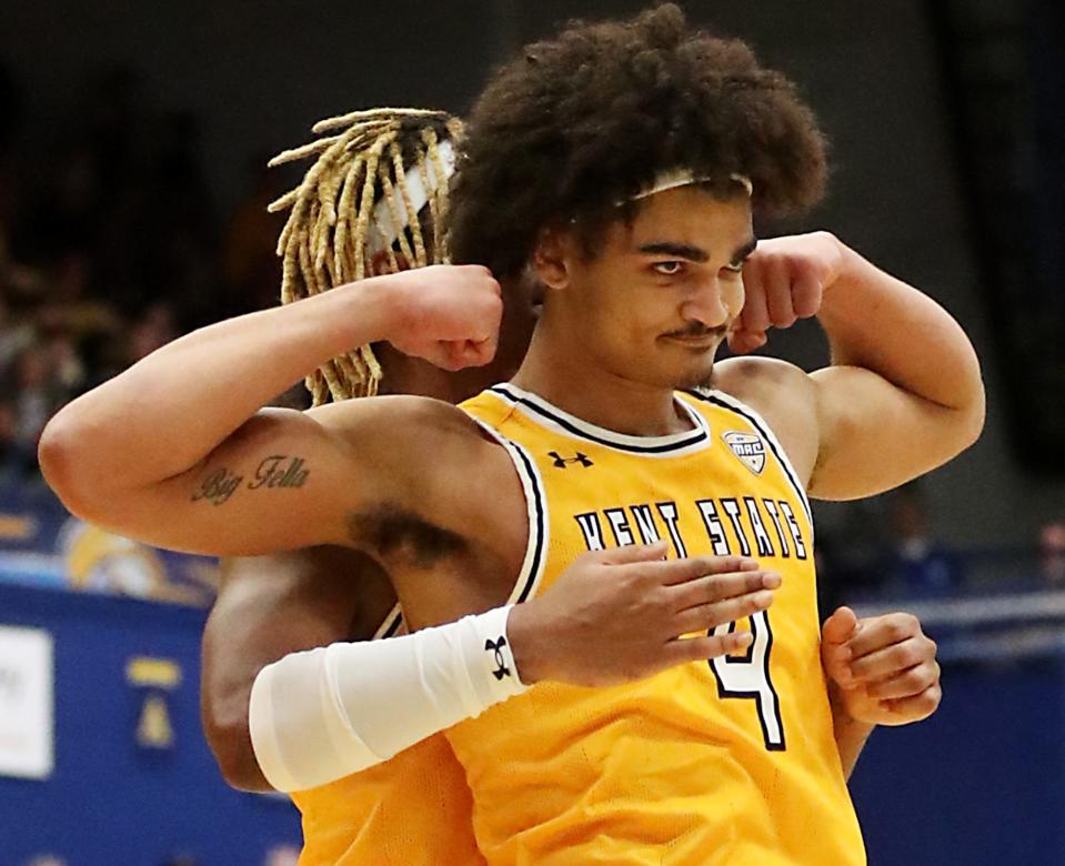 Kent State's VonCameron Davis celebrates as Chris Payton flexes after a dunk against Akron during their game at the MAC Center in Kent on Friday. The flashes beat the Zips 89-84 in overtime.