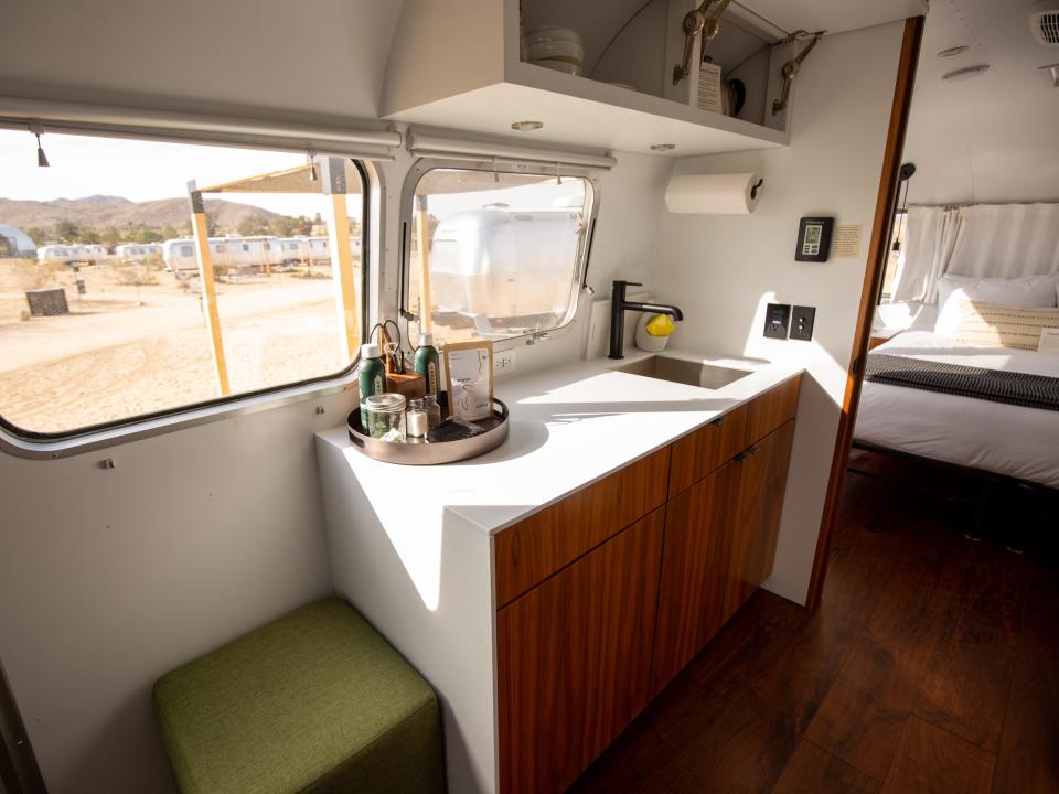 Autocamp Joshua Tree's Airsteram trailer with a kitchen near the bedroom and windows.