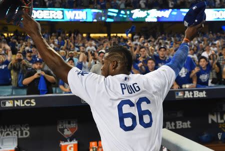 Oct 15, 2017; Los Angeles, CA, USA; Los Angeles Dodgers right fielder Yasiel Puig (66) celebrates after defeating the Chicago Cubs in game two of the 2017 NLCS playoff baseball series at Dodger Stadium. Mandatory Credit: Jayne Kamin-Oncea-USA TODAY Sports