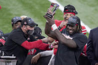 Ohio State running back Trey Sermon, right, is congratulated by head coach Ryan Day, left, after being named most valuable player following the Big Ten championship NCAA college football game, Saturday, Dec. 19, 2020, in Indianapolis. Ohio State defeated Northwestern 22-10. (AP Photo/Darron Cummings)