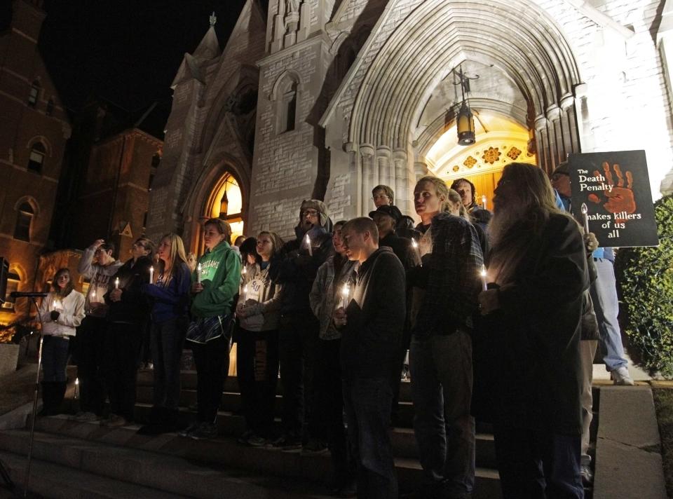 Supporters of "Missourians for Alternatives to the Death Penalty" (MADP) attend a candlelight vigil for death row inmate Joseph Franklin on the steps of St. Francis Xavier Church in St. Louis