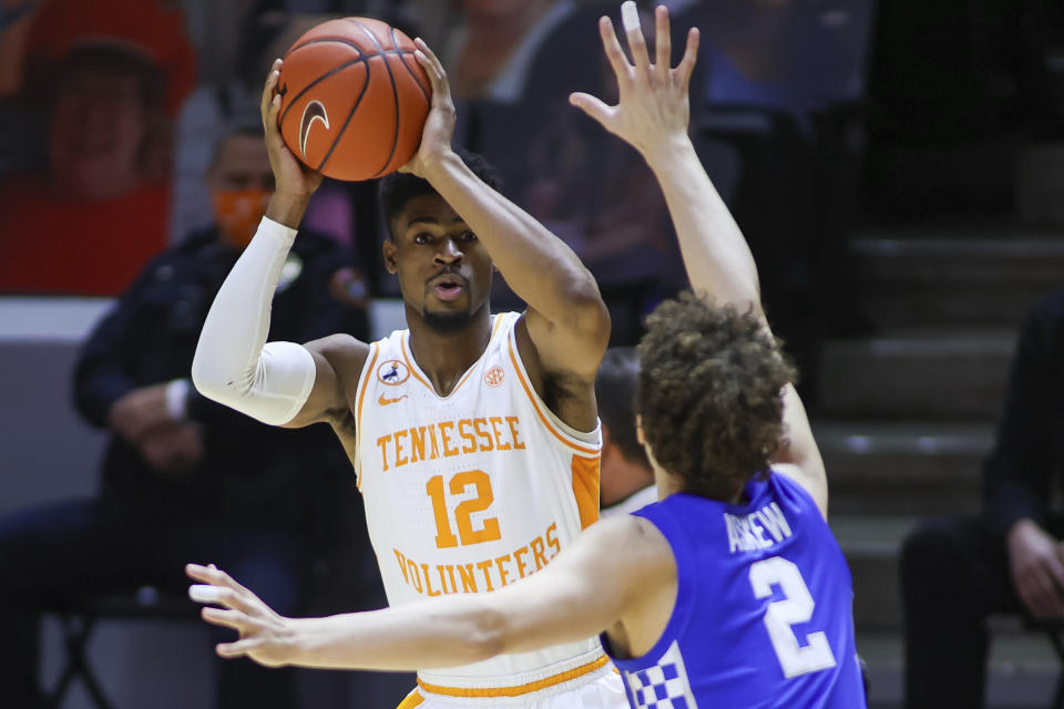 Tennessee guard Victor Bailey Jr. (12) looks to pass the ball against Kentucky's Devin Askew (2) during an NCAA college basketball game Saturday, Feb. 20, 2021, in Knoxville, Tenn. (Randy Sartin/Pool Photo via AP)