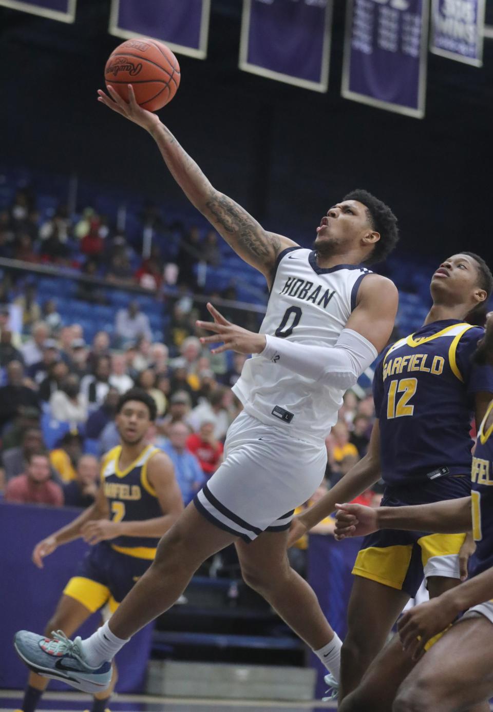 Hoban's Jonas Nichols drives past Garfield Heights' Deandre Jones in a regional semifinal, Wednesday, March 13, 2024, at Rhodes Arena.