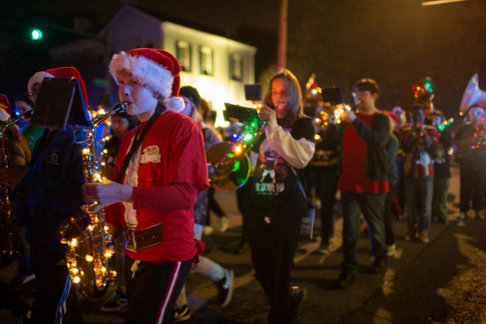 The E.A. Cox Middle School Band marches past the James K. Polk Home & Museum during  the Columbia Main Street Christmas Parade in Columbia, Tenn., on Saturday, Dec. 4, 2021.