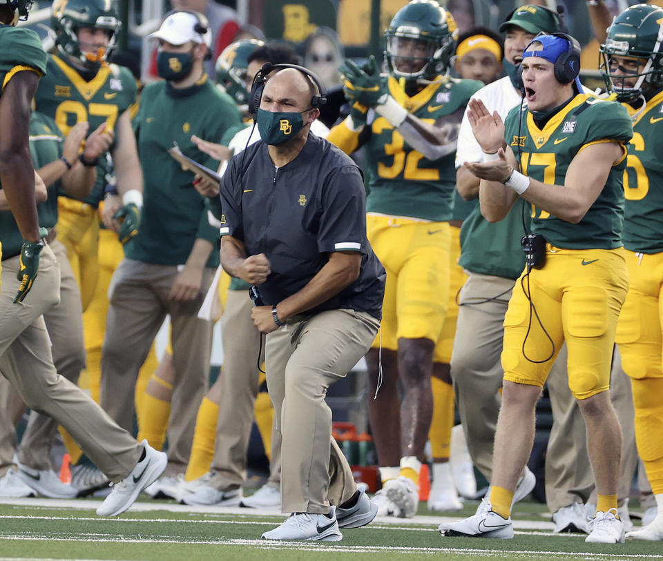 FILE - In this Sept. 26, 2020, file photo, Baylor head coach Dave Aranda reacts as the defense stopped Kansas on fourth down in the first half of an NCAA college football game in Waco, Texas. Baylor was supposed to start its season on Sept. 12, but Louisiana Tech was forced to pull out four days before. Bears coach Dave Aranda tried to alleviate some of the disappointment by holding a socially distanced, Thursday night NFL watch party for the team using the video board in McLane Stadium. (Jerry Larson/Waco Tribune-Herald via AP, File)