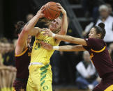Arizona State's Robbi Ryan, left, and Reili Richardson, right, defend against Oregon's Sabrina Ionescu near the end of an NCAA college basketball game Friday, Jan 18, 2019, in Eugene, Ore. Ionescu was fouled on the play. (AP Photo/Chris Pietsch)