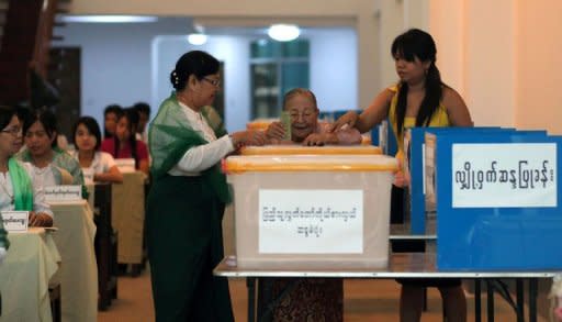 An elderly woman casts her vote at a polling station in Yangon on April 1, 2012