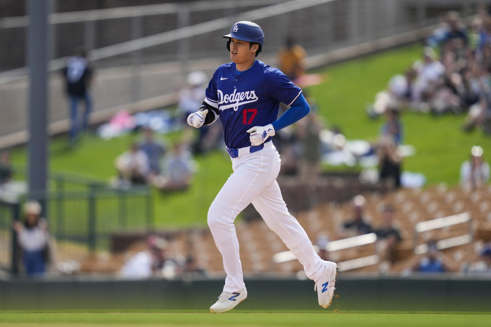 Los Angeles Dodgers designated hitter Shohei Ohtani runs the bases after hitting a home run during the fifth inning of a spring training baseball game against the Chicago White Sox in Phoenix, Tuesday, Feb. 27, 2024. Jose Ramos also scored. (AP Photo/Ashley Landis)