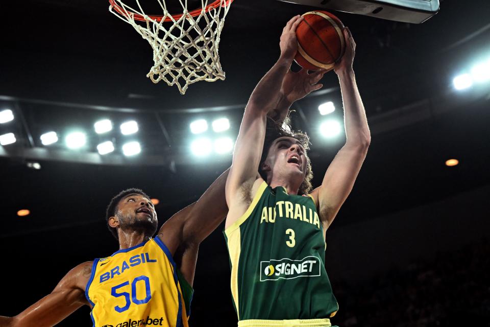 Australia’s Josh Giddey (R) takes a rebound ahead of Brazil’s Bruno Cabodo (L) during the international friendly basketball match between Australia and Brazil in Melbourne on August 16, 2023, in preparation for the 2023 Philippines-Japan-Indonesia FIBA Basketball World Cup. (Photo by William WEST / AFP) / –IMAGE RESTRICTED TO EDITORIAL USE – STRICTLY NO COMMERCIAL USE– (Photo by WILLIAM WEST/AFP via Getty Images)