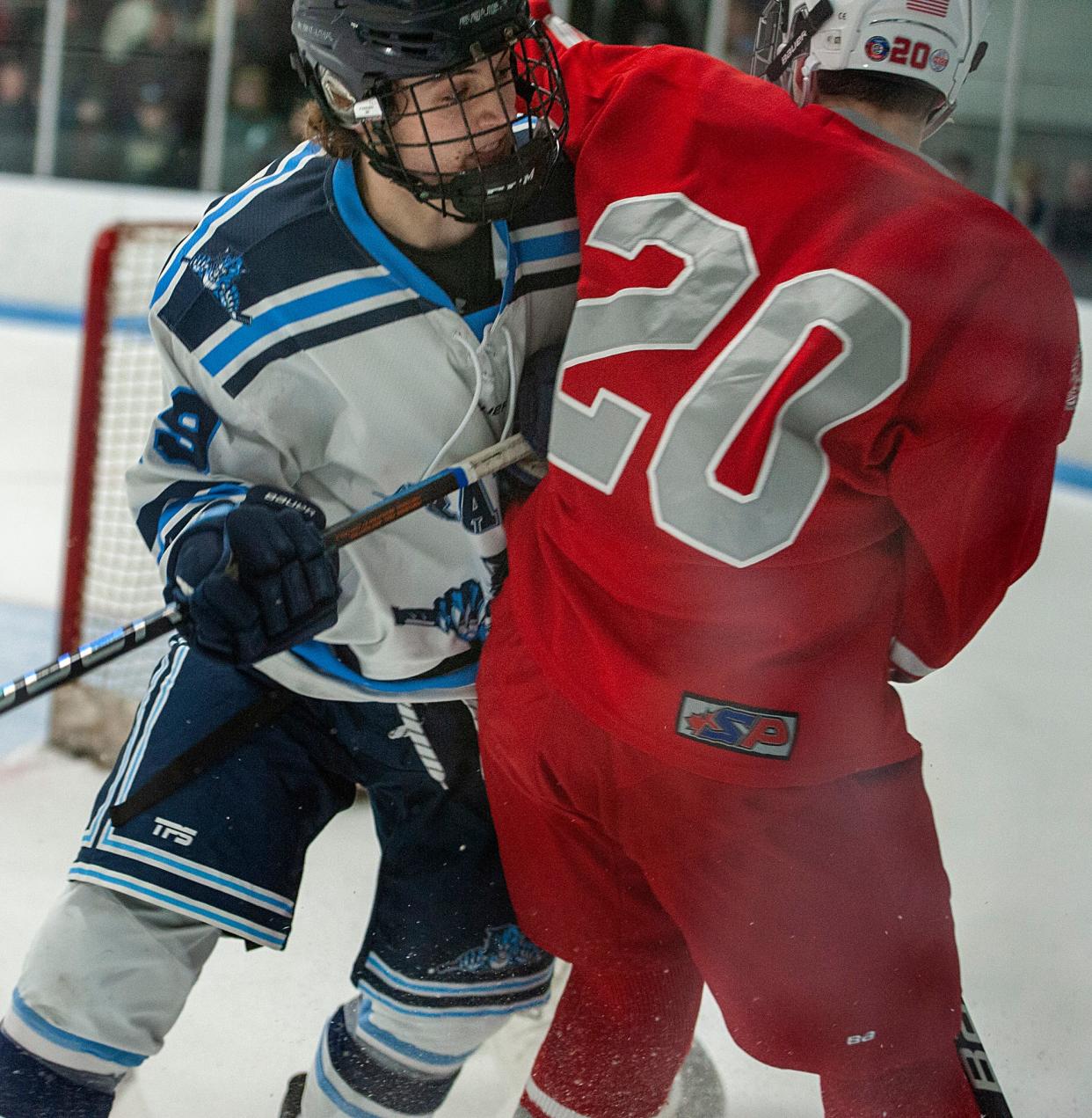 Franklin High School hockey player junior Dylan McEvoy checks Catholic Memorial junior Adam Parker at Pirelli Arena, Jan. 27, 2023.