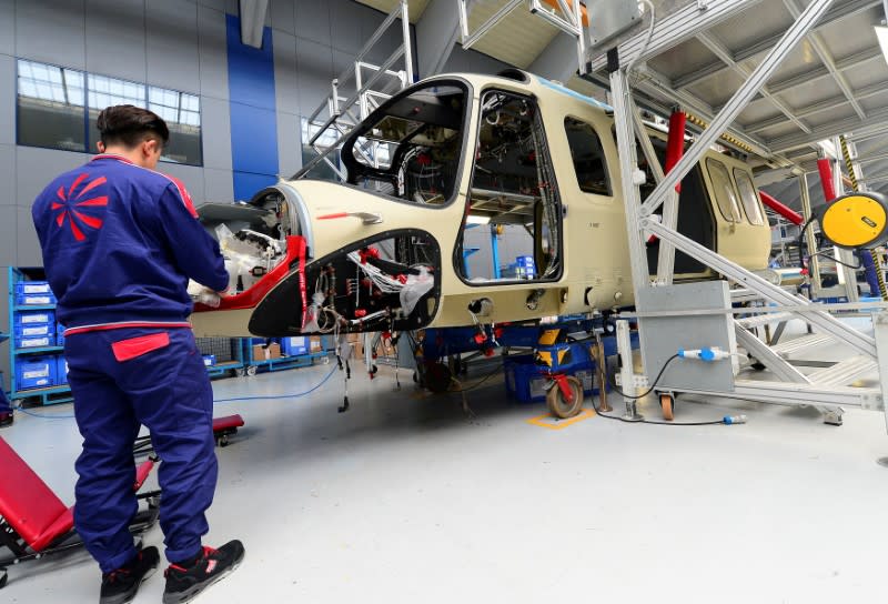 FILE PHOTO: Leonardo's employee works on the AgustaWestland AW189 helicopter at the headquarters in Vergiate