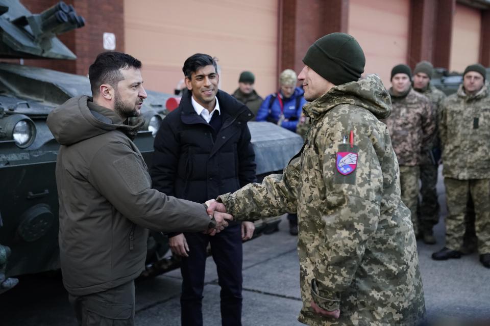 Prime Minister Rishi Sunak and Ukrainian President Volodymyr Zelenskuy meet Ukrainian troops being trained to command Challenger 2 tanks at a military facility on February 8, 2023 in Lulworth, Dorset, England.