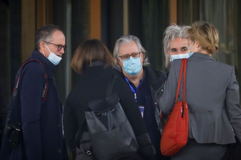 Members of the World Health Organisation (WHO) team tasked with investigating the origins of the coronavirus (COVID-19) pandemic, talk outside their hotel after returning from their second field trip in Wuhan