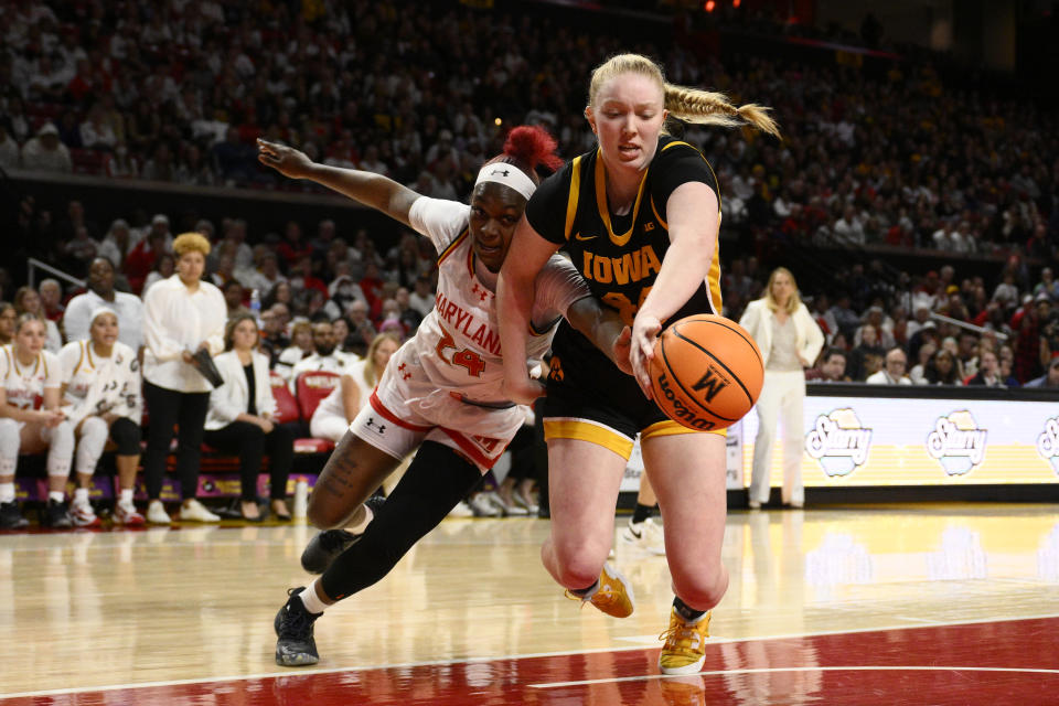 Maryland guard Bri McDaniel (24) and Iowa forward Addison O'Grady, right, battle for the ball during the second half of an NCAA college basketball game, Saturday, Feb. 3, 2024, in College Park, Md. (AP Photo/Nick Wass)