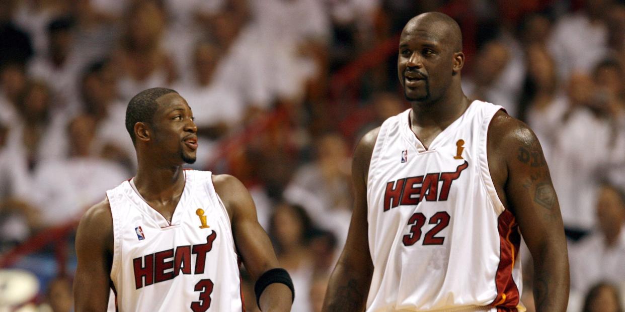 Dwyane Wade looks up, smiling, at  Shaquille O'Neal during a game in 2006.