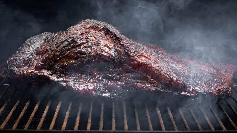 Smoke rising around smoked brisket