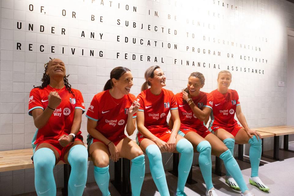 a group of women sitting on a bench