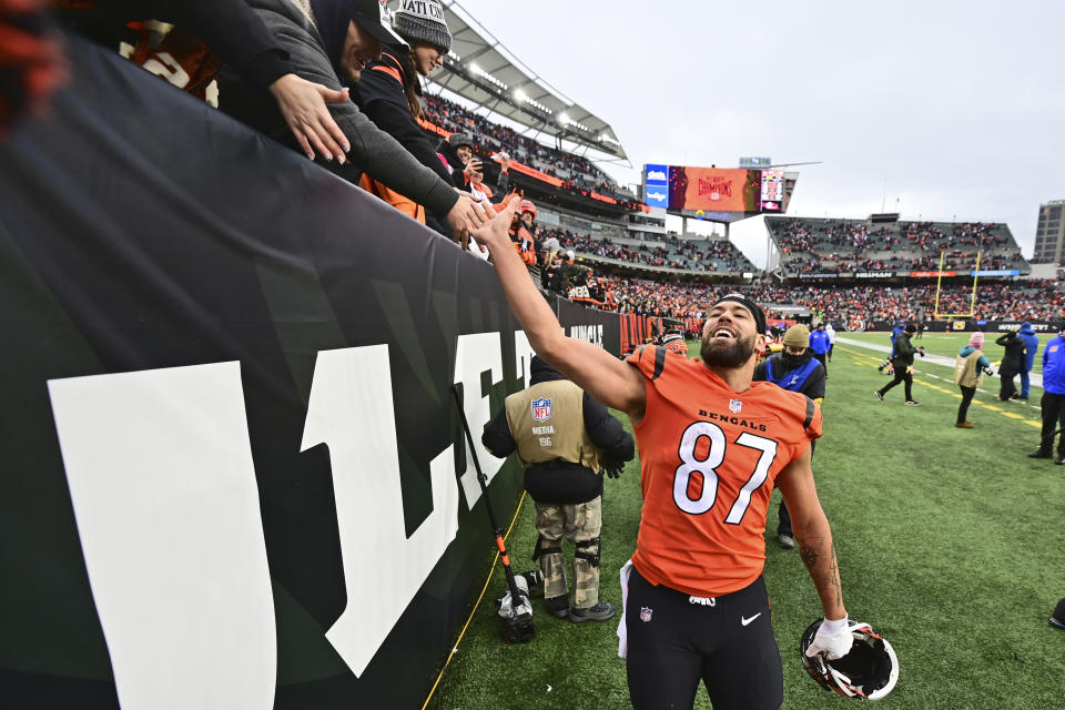 Cincinnati Bengals tight end C.J. Uzomah (87) celebrates with fans after the Bengals defeated the Kansas City Chiefs 34-31 in an NFL football game, Sunday, Jan. 2, 2022, in Cincinnati. (AP Photo/David Dermer)