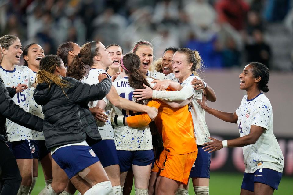 The USWNT mobs goalie Alyssa Naeher after the victory over Canada in a penalty shootout.