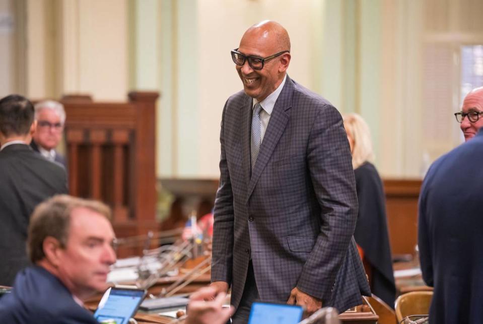 Assemblyman Chris Holden, D-Pasedena, chats with fellow lawmakers in the Assembly chamber at the state Capitol in September 2023. Holden authored a bill to place limits on solitary confinement in prisons, jails and immigrant detention facilities.