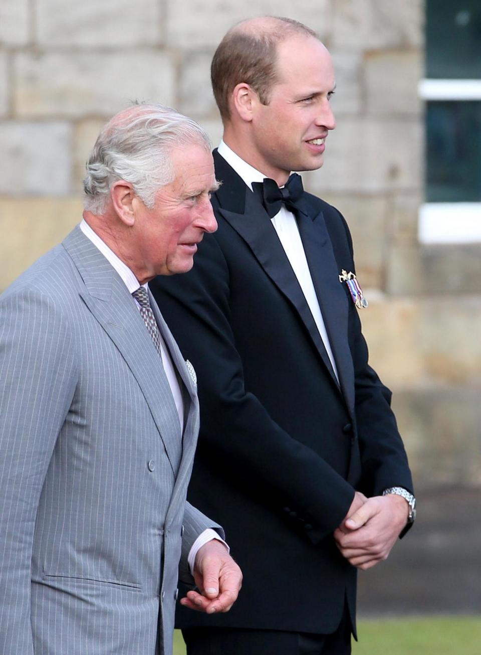 Family outing: The Prince of Wales and the Duke of Cambridge view a performance (PA)