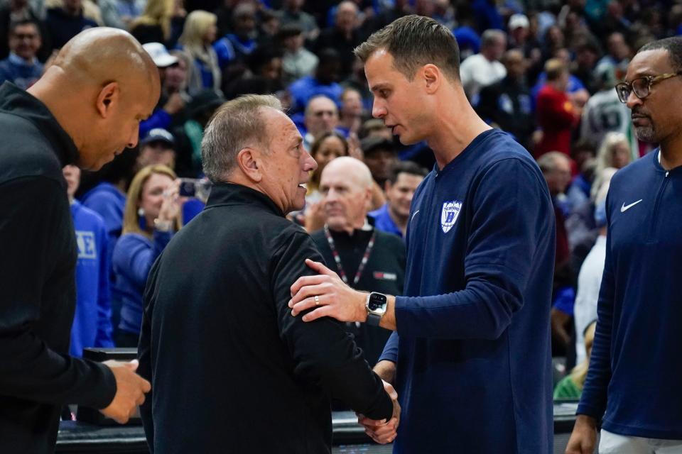 Duke head coach Jon Scheyer, right, shakes hands with Michigan State head coach Tom Izzo in the Champions Classic at the United Center on Tuesday, Nov. 14, 2023, in Chicago, Illinois.