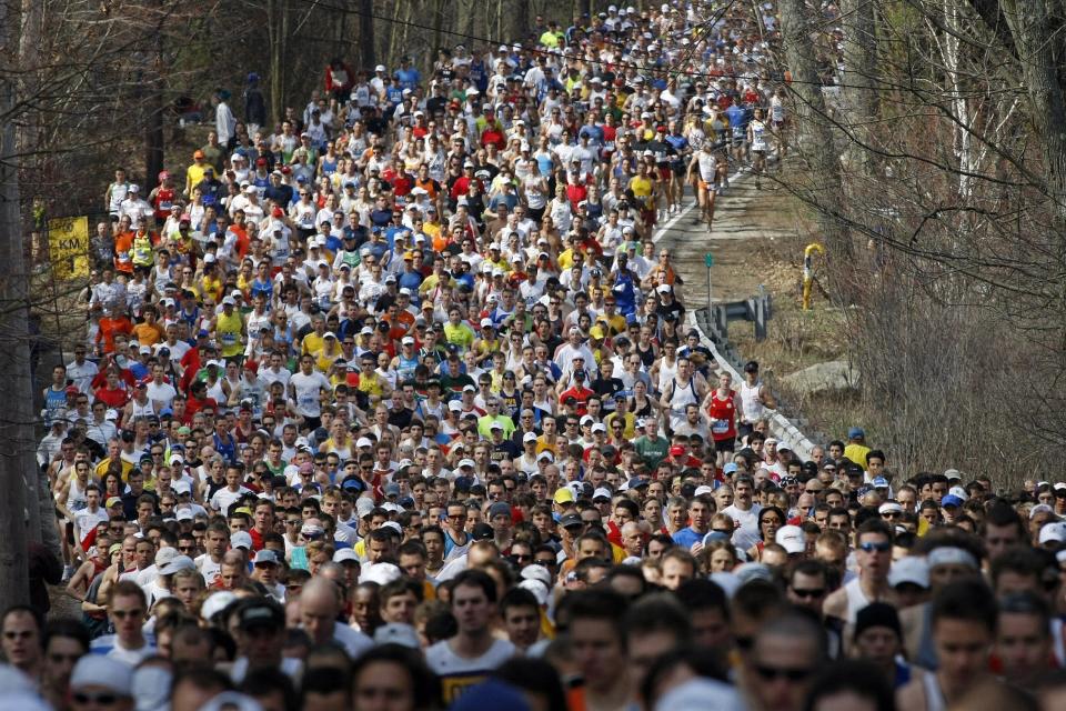 FILE - In this April 21, 2008, file photo, runners round a curve and climb a hill near during the first mile of the 112th Boston Marathon in Hopkinton, Mass. Due to the COVID-19 virus pandemic, the 124th running of the Boston Marathon was postponed from its traditional third Monday in April to Monday, Sept. 14, 2020. (AP Photo/Greg M. Cooper, File)