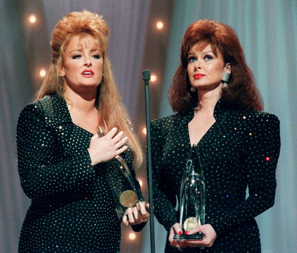 In an emotional farewell, Wynonna, left, and Naomi Judd accept their eighth consecutive CMA award during the 25th annual CMA Awards show at the Grand Ole Opry House Oct. 2, 1991. The Judds announced they were breaking up as an act after a concert in Murfreesboro because Naomi was going to retire due to a lingering case of hepatitis.