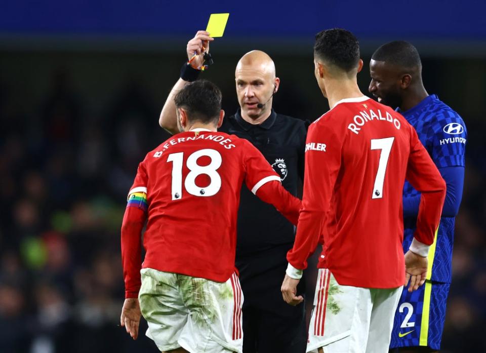 Bruno Fernandes is shown a yellow card by referee Anthony Taylor (REUTERS)